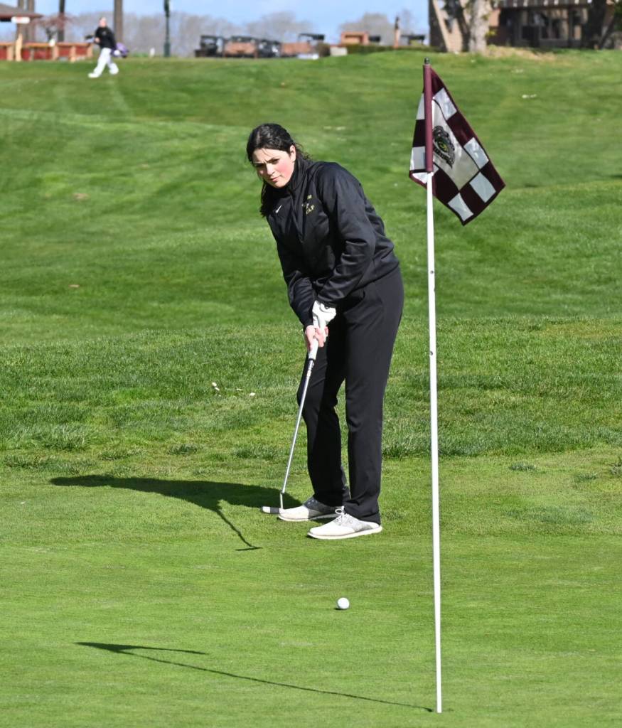 Isabella Williams watches a putt on the first hole in a league match against Kingston at The Cedars at Dungeness on March 31. Sequim Gazette photo by Michael Dashiell