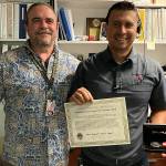 Photo courtesy City of Port Angeles
In March, the Port Angeles Police Department, represented by PenCom deputy director Karl Hatton, on left, honored Dennis Laboy, a communications supervisor from Sequim, the Life Saving Award for his efforts back in September 2021 to help a woman over the phone perform CPR on her husband. The man lived thanks to Laboy and the wifes actions prior to paramedics arriving.