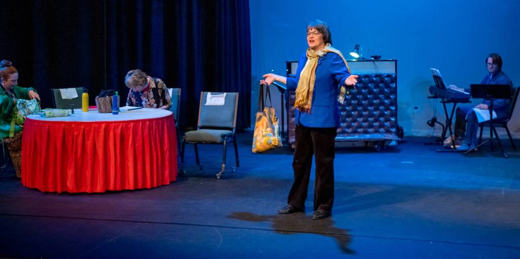 Becky Horst, as Bernice, sings a solo on a spare set reminiscent of a Bingo Hall underattended due to bad weather. Sandy Altman is set designer for Bingo the Winning Musical, debuting April 15 at Olympic Theatre Arts in Sequim. Sequim Gazette photo by Emily Matthiessen