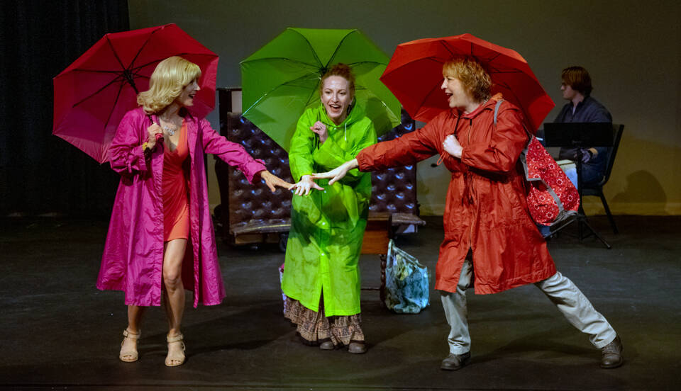 Old friends Honey, Patsy and Vern played by Mindy Gelder, Susan Cates and Rebecca Gilbert psych each other up to go to the bingo hall during a deluge. Behind, musical director Morgan Bartholick plays the keyboard. Sequim Gazette photo by Emily Matthiessen