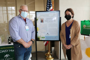 Photo courtesy of Olympic Medical Center
Olympic Medical Center nurse Wade Lauritzen receives his DAISY Award for Extraordinary Nurses from OMC Chief Nursing Officer Vickie Swanson.