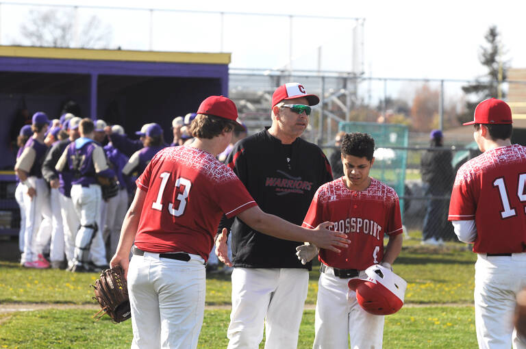 Crosspoint Academy head coach Derrin Doty, a former Sequim High standout, talks with his players in an April 15 non-league match-up in Sequim. Sequim Gazette photo by Michael Dashiell