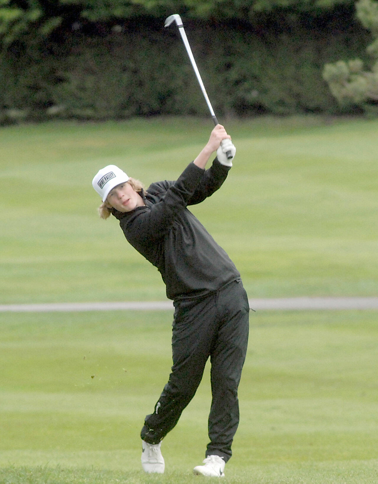 Sequims Ben Sweet hits from the fairway on the first hole against Port Angeles on April 15 at Peninsula Golf Club. Sweet shot a 4-over-par 40, one shot back of medalist teammate Dominick Riccobene. Photo by Keith Thorpe/Olympic Peninsula News Group