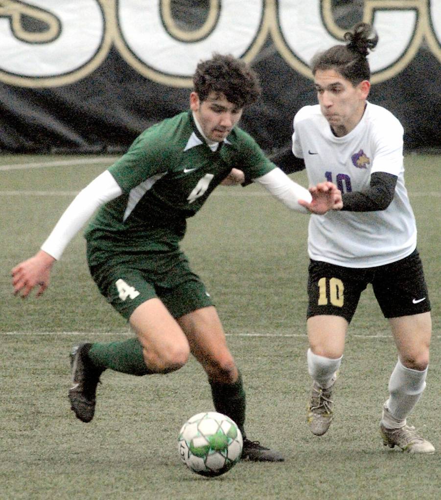 Port Angeles Keane McClain, left, and Sequims Rafael Flores battle for the ball on March 12 at Peninsula College in Port Angeles. Photo by Keith Thorpe/Olympic Peninsula News Group