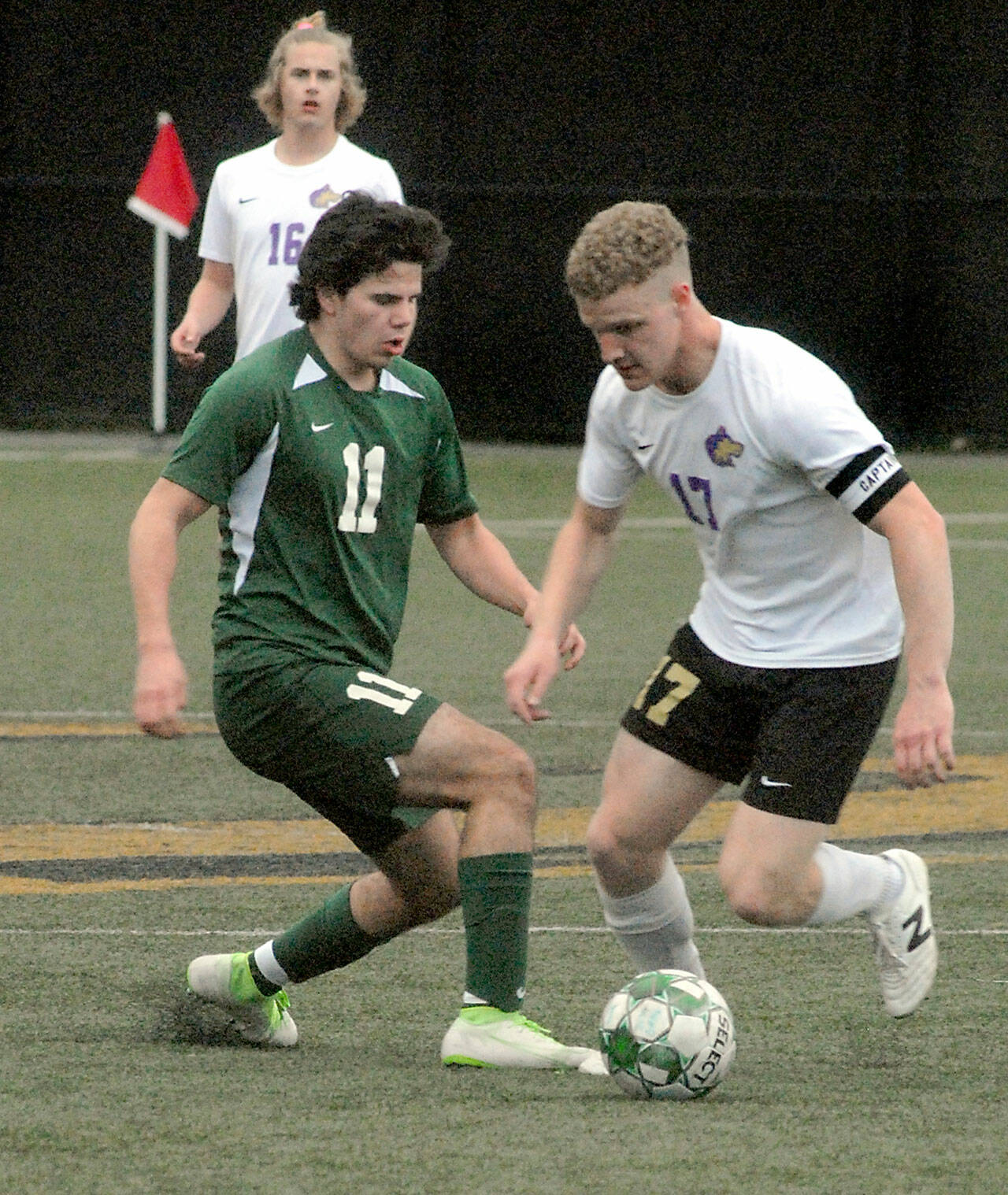 Photos by Keith Thorpe/Olympic Peninsula News Group
Port Angeles Xander Maestas, left, and Sequims Aidan Henninger face off for ball control as Sequims Harrison Bell looks on during an April 12 Olympic League match at Peninsula College in Port Angeles.