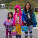 Sequim Gazette photo by Emily Matthiessen
From left, Camilla Peterson, 3, Delphina Peterson, 6, and Logan Peterson, 8, were enthusiastic participants at three egg hunts, finishing up in the snow and hail at KSQM 91.5 FM and the Pumpkin Patchs hunt off Highway 101. Drenched and happy, they pose for a picture before returning home.
