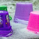Sequim Gazette photos by Emily Matthiessen
Stacks of plastic Easter pails surrounded by icy snow at the Pumpkin Patch off Highway 101 in Sequim speak of the lower than expected turnout for the traditional Easter Egg, due to a brief storm of hail, snow and thunder that descended upon Sequim on Saturday. Susan Sorenson of co-sponsor KSQM 91.5 said that the radio played announcements to start the hunt earlier than the scheduled 1 p.m. start time.