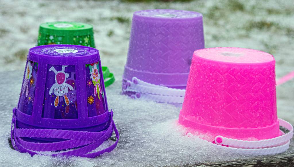 Sequim Gazette photos by Emily Matthiessen
Stacks of plastic Easter pails surrounded by icy snow at the Pumpkin Patch off Highway 101 in Sequim speak of the lower than expected turnout for the traditional Easter Egg, due to a brief storm of hail, snow and thunder that descended upon Sequim on Saturday. Susan Sorenson of co-sponsor KSQM 91.5 said that the radio played announcements to start the hunt earlier than the scheduled 1 p.m. start time.