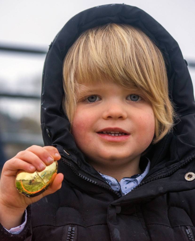 Sequim Gazette photos by Emily Matthiessen
Maximilian Dempsey, 3, finds the special golden egg Pumpkin Patch Egg Hunt off Highway 101, co-hosted by KSQM 91.5. Dempsey was one of a small crowd of children who turned out for the hunt despite a hail, snow and thunderstorm that hit Sequim briefly on Saturday.