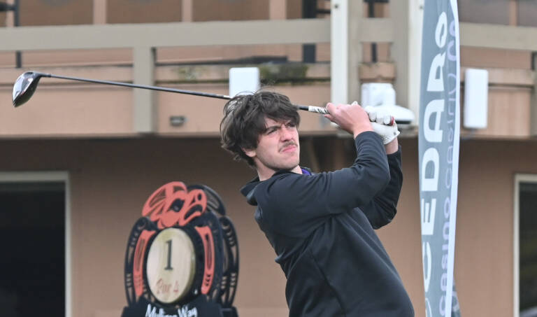 Sequim's Cole Smithson tees off on the first hole in an April 21 match against Bainbridge. Sequim Gazette photo by Michael Dashiell