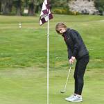 Sequim's Hanna Wagner lines up a putt on the first hole in an April 21 match against Bainbridge. Sequim Gazette photo by Michael Dashiell
