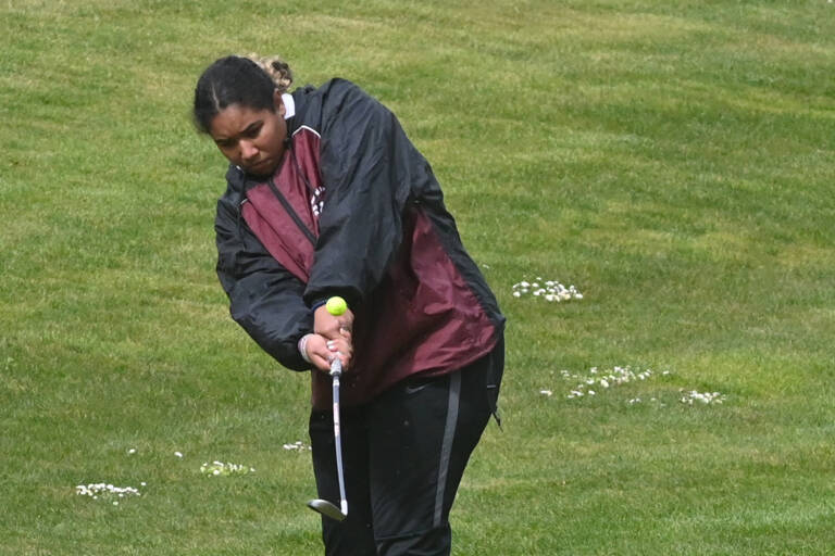 Sequim's Jelissa Julmist hits an approach shot on the first hole in an April 21 match against Bainbridge. Sequim Gazette photo by Michael Dashiell