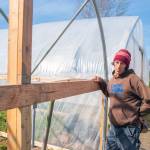 Scoot Chichester pauses outside Chis Farms newest greenhouse, being built with loans from community members that will be paid back utilizing a USDA grant after completion. Sequim Gazette photo by Emily Matthiessen