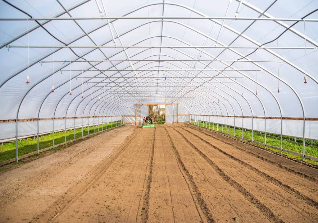 The interior of a greenhouse ready to be planted at Chis Farm in Sequim. The eight greenhouses on the farm make it possible for Chis to provide locals with salad greens year round and heat-loving produce in the summer and fall. Sequim Gazette photo by Emily Matthiessen