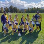 Photo courtesy of Erin Henderson
Carter Pace, in center, was a star soccer play with Sequim Junior Soccer before being diagnosed with brain cancer last summer. Erin Henderson, SJS Registar says, Carter and his siblings have played with Sequim Junior Soccer for many years, and his family has always been a wonderful addition to our club. Carter played a very important role on his SJS Elite (Select Soccer) team, and is loved by his teammates. When Carter was diagnosed at the very start of their Select Season in 2021, his team banded together to Fight for #10. They even all got matching wrist bands to wear during games with Carters #10 on it, so that he was always there playing with him, even when he couldnt be there physically. Carter was able to come watch just a few games over the season when he was feeling well enough, and his team was thrilled to have him there. Carters mother Becca is knitting beanies in purple and gold colors for sports fans in the area. Proceeds go to funding supplies for donating beanies to other children who lose their hair during cancer treatment.