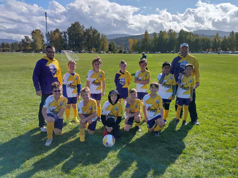 Photo courtesy of Erin Henderson
Carter Pace, in center, was a star soccer play with Sequim Junior Soccer before being diagnosed with brain cancer last summer. Erin Henderson, SJS Registar says, Carter and his siblings have played with Sequim Junior Soccer for many years, and his family has always been a wonderful addition to our club. Carter played a very important role on his SJS Elite (Select Soccer) team, and is loved by his teammates. When Carter was diagnosed at the very start of their Select Season in 2021, his team banded together to Fight for #10. They even all got matching wrist bands to wear during games with Carters #10 on it, so that he was always there playing with him, even when he couldnt be there physically. Carter was able to come watch just a few games over the season when he was feeling well enough, and his team was thrilled to have him there. Carters mother Becca is knitting beanies in purple and gold colors for sports fans in the area. Proceeds go to funding supplies for donating beanies to other children who lose their hair during cancer treatment.
