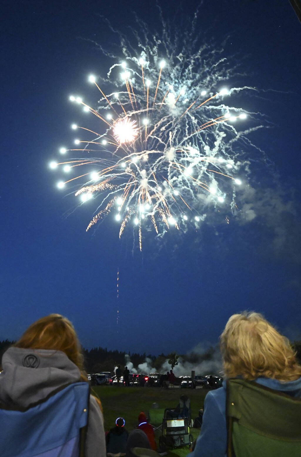 Onlookers enjoy the City of Sequims Fourth of the July fireworks show from the nearby James Center for the Performing Arts bandshell in 2021. Sequim Gazette file photo by Michael Dashiell