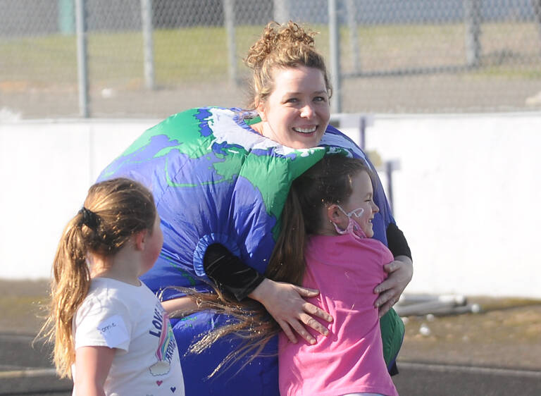 Assistant principal Sarah Decker gets a hug from first-grader Ava Korwel at Helen Haller Elementary's School's annual Fun Run, held on Earth Day (April 22). Sequim Gazette photo by Michael Dashiell