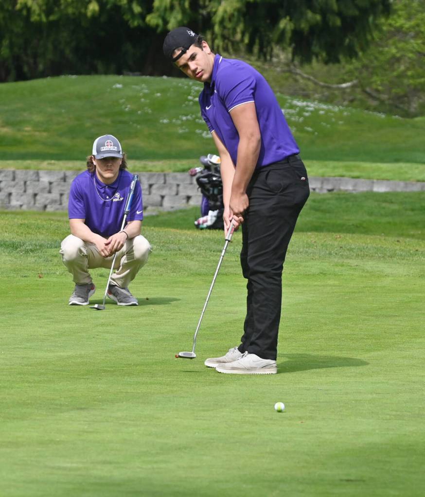 Sequims Pryce Glasser looks to sink a putt at the 11th hole during an April 28 Olympic League match against North Kitsap. Sequim Gazette photo by Michael Dashiell