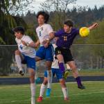 As Knights Aidan Harvey (2) and Diego Clemen (6) defend, Sequims Ethan Knight goes up for a header in the Wolves April 26 home league game against Bremerton. Sequim Gazette photo by Emily Matthiessen