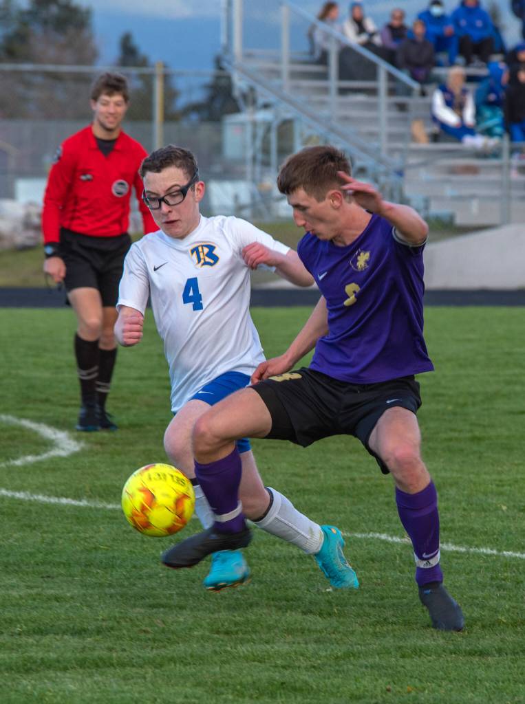 Sequims Brandon Wagner, right, vies for the ball with Bremertons Ryan Bell in the Wolves 3-1 home loss to the Knights on April 26. Sequim Gazette photo by Emily Matthiessen
