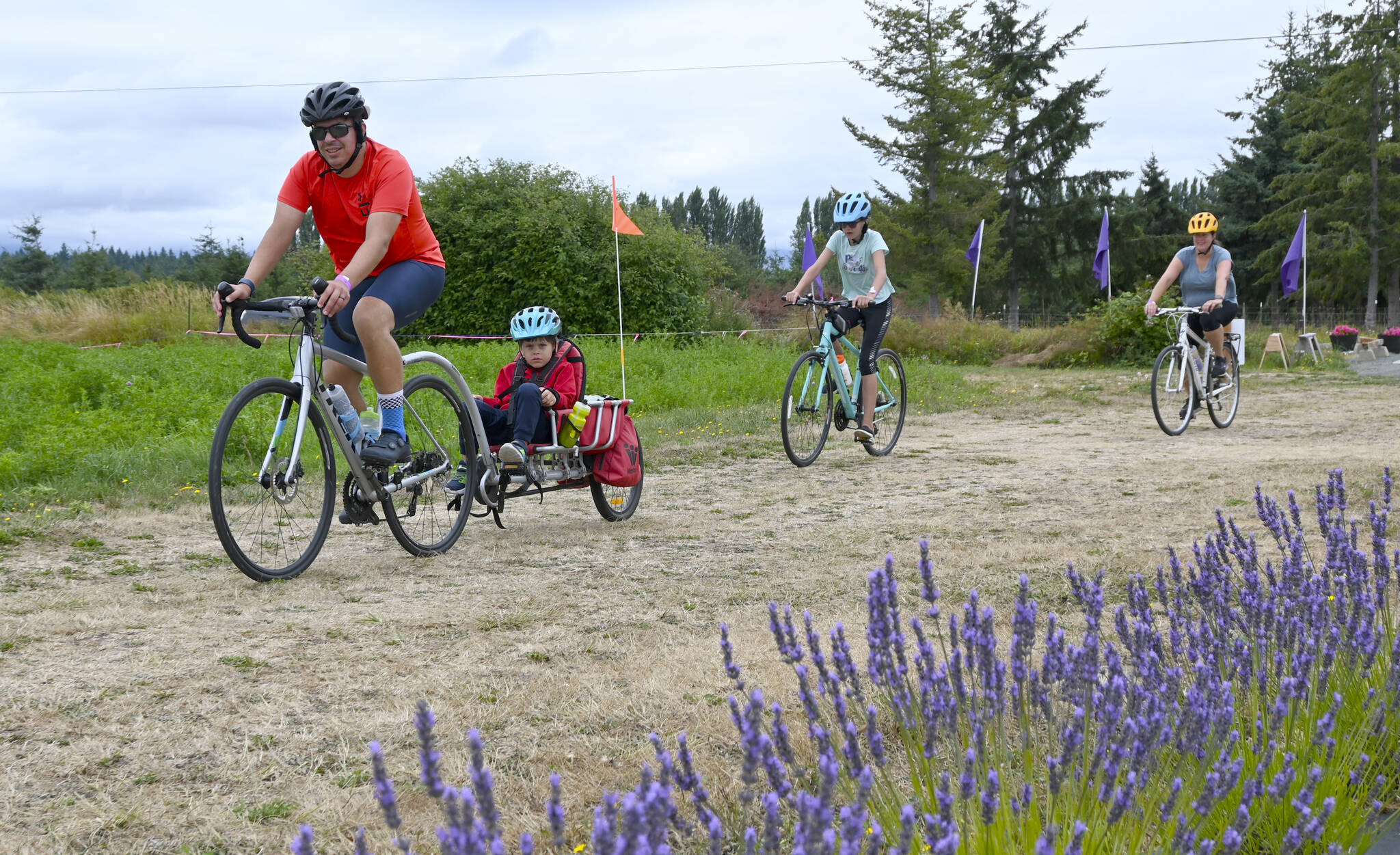 From left, Greg Roe and family  children Andrew, 5, and Charlotee, 11, with wife Bridget McKay  enjoy the Tour de Lavender Fun Ride in 2021. The group was enjoying a day trip from the Lake Stevens area. Sequim Gazette file photo by Michael Dashiell