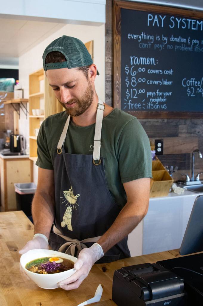 David Rivers, co-manager, serves a hot bowl of ramen at Soup in the Alley, where diners can pay what they can afford for lunch Monday through Friday Sequim Gazette photo by Emily Matthiessen