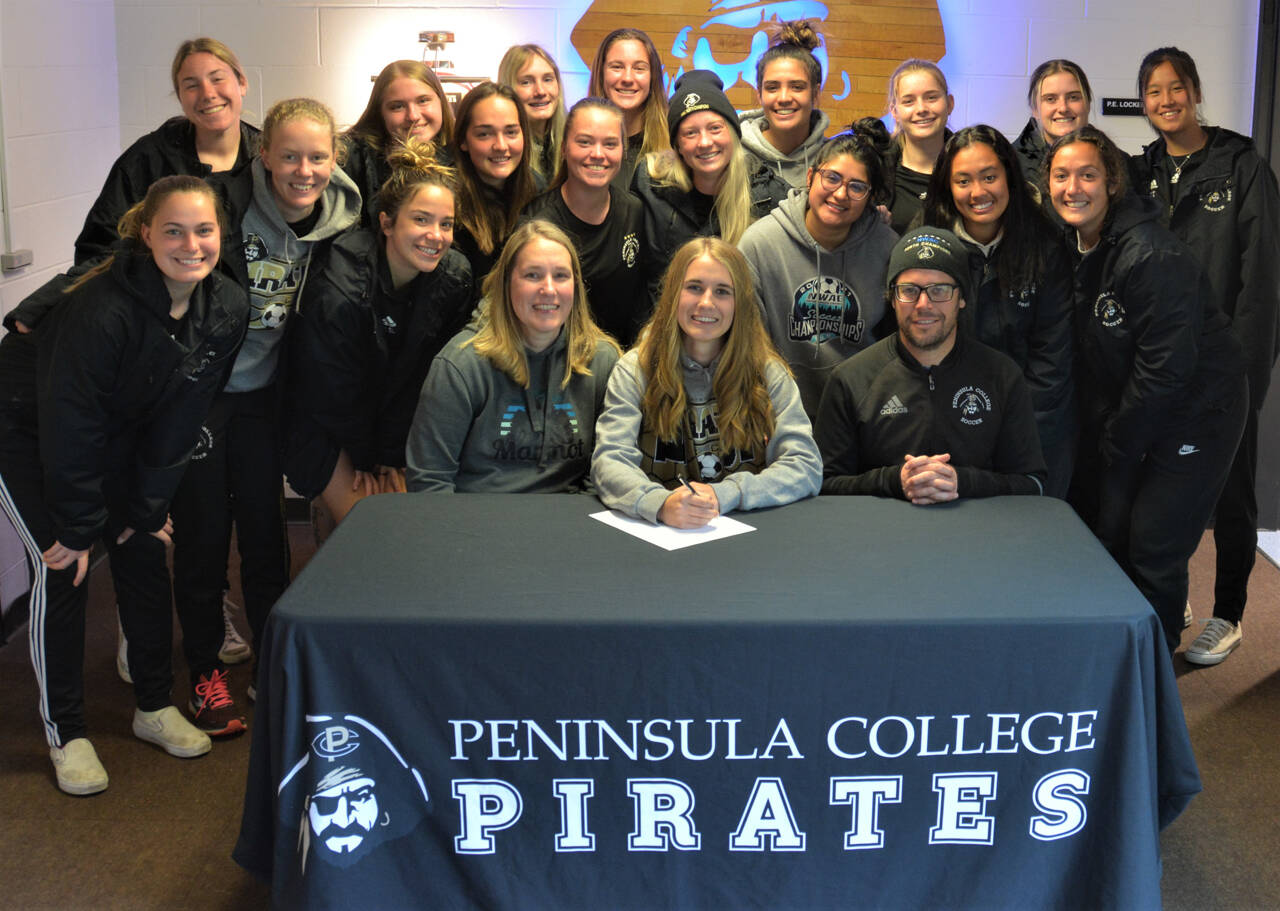 Sequims Hannah Wagner, center, signs a letter of intent to play for Peninsula Colleges womens soccer team next season. Photo courtesy of Rick Ross/Peninsula College