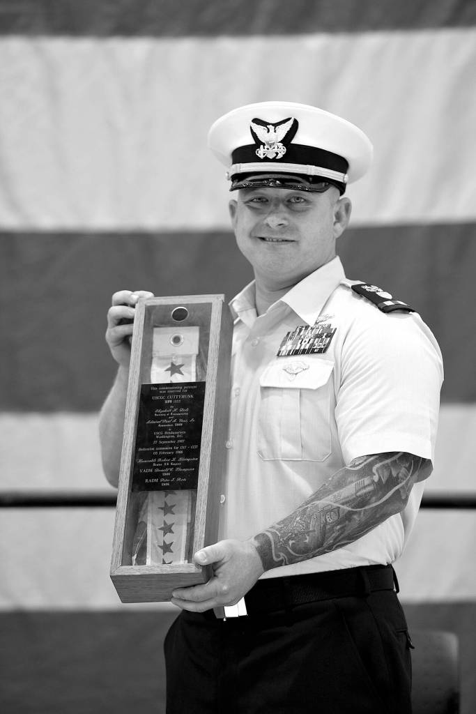 Chief Warrant Officer Daniel Garver received the Coast Guard Cutter Cuttyhunk's commissioning pennant during a ceremony held Thursday, May 5, 2022, at Air Station Port Angeles. The ceremony was held to decommission the Cuttyhunk, and Garver, the vessel's commanding officer, received the pennant in accordance with tradition. (U.S. Coast Guard photo by Petty Officer 3rd Class Michael Clark)