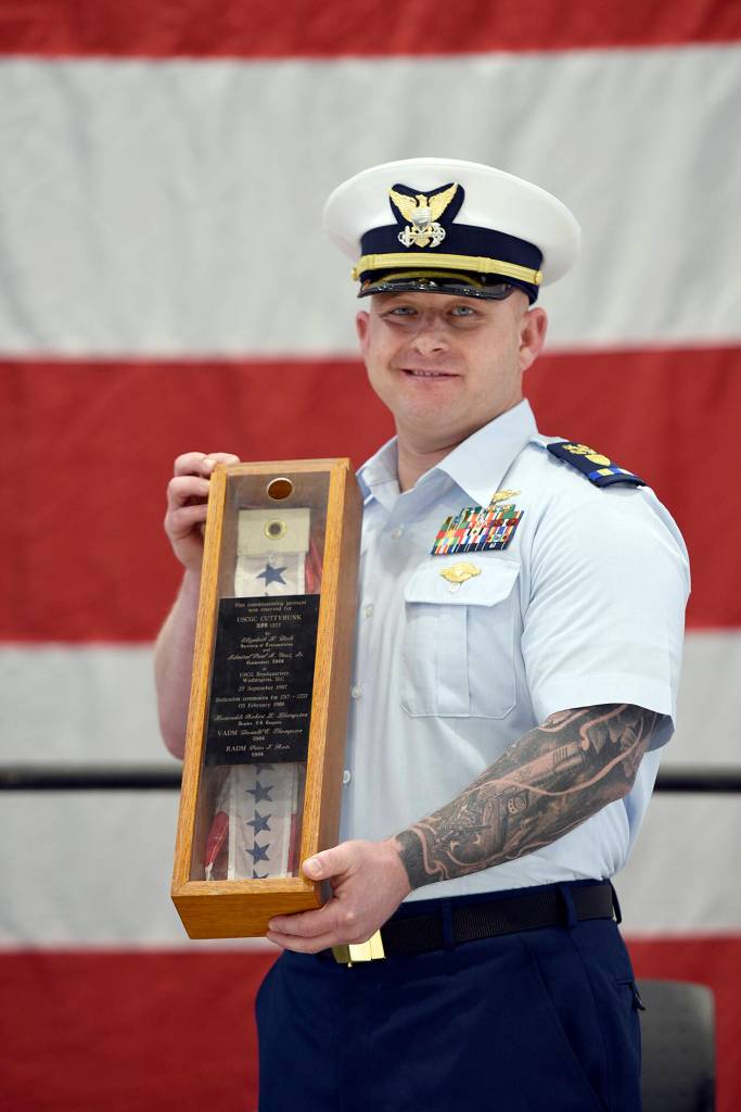 Chief Warrant Officer Daniel Garver received the Coast Guard Cutter Cuttyhunk's commissioning pennant during a ceremony held Thursday, May 5, 2022, at Air Station Port Angeles. The ceremony was held to decommission the Cuttyhunk, and Garver, the vessel's commanding officer, received the pennant in accordance with tradition. (U.S. Coast Guard photo by Petty Officer 3rd Class Michael Clark)