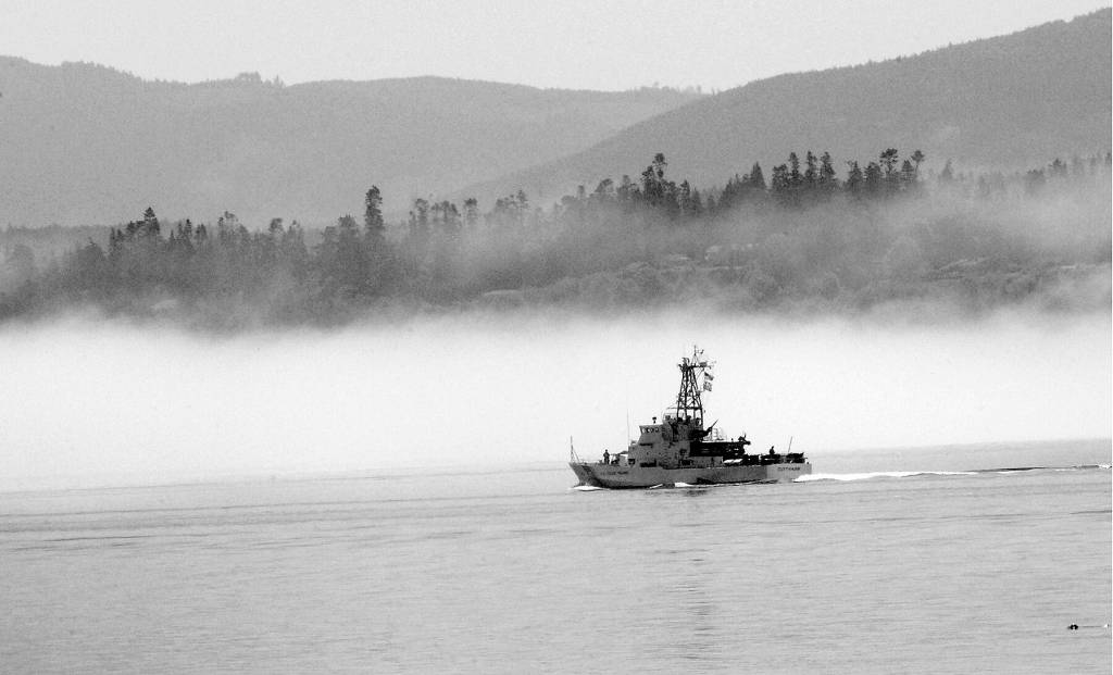 Keith Thorpe/Olympic Peninsula News Group
The U.S. Coast Guard cutter Cuttyhunk sails across Port Angeles Harbor against a backdrop of fog hugging the shoreline in June 2020.