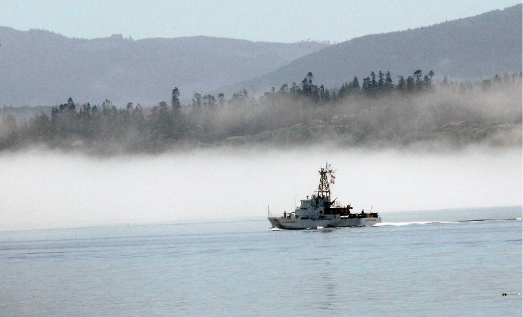 Keith Thorpe/Olympic Peninsula News Group
The U.S. Coast Guard cutter Cuttyhunk sails across Port Angeles Harbor against a backdrop of fog hugging the shoreline in June 2020.