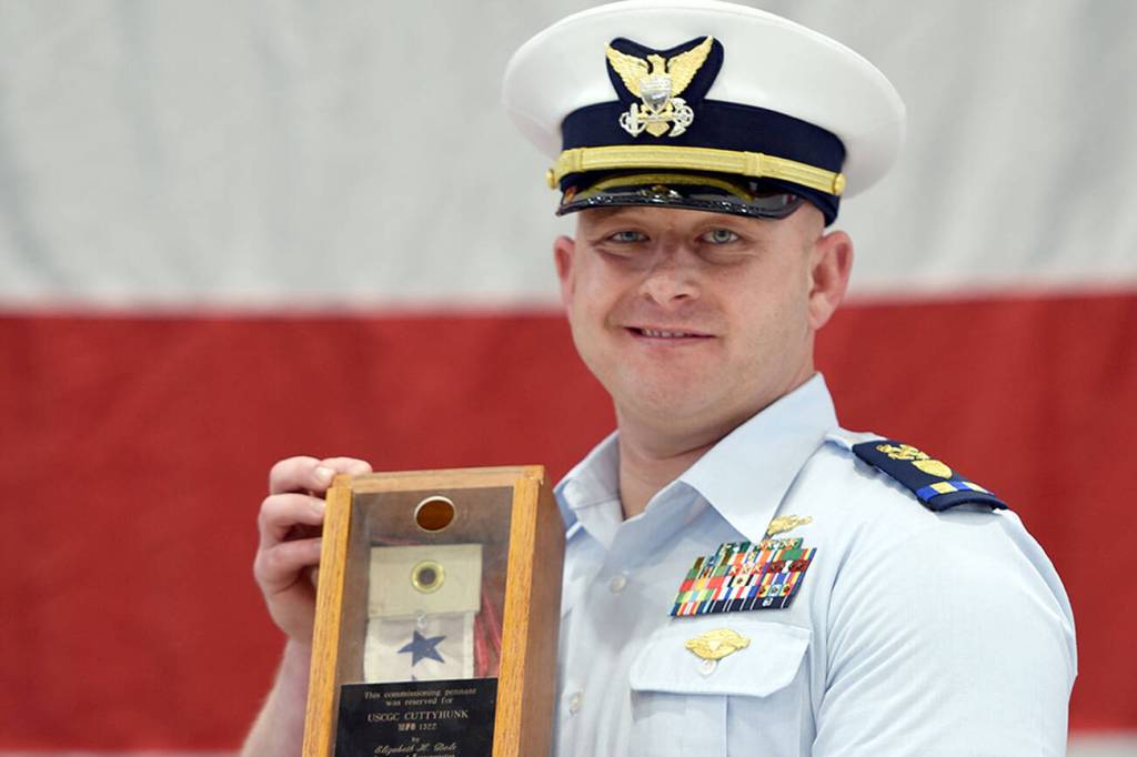 Chief Warrant Officer Daniel Garver received the Coast Guard Cutter Cuttyhunk's commissioning pennant during a ceremony held Thursday, May 5, 2022, at Air Station Port Angeles. The ceremony was held to decommission the Cuttyhunk, and Garver, the vessel's commanding officer, received the pennant in accordance with tradition. (U.S. Coast Guard photo by Petty Officer 3rd Class Michael Clark)