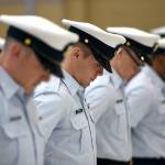 The crew of Coast Guard Cutter Cuttyhunk (WPB 1322) bow their heads during a benediction prayer starting the cutters decommissioning ceremony held Thursday, May 5, 2022, at Air Station Port Angeles. The crew would transition from the Cuttyhunk to the Anacapa, another 110-foot Island Class patrol boat which would in turn serve the Pacific Northwest. Photo by U.S. Coast Guard photo by Petty Officer 3rd Class Michael Clark
