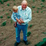Photo courtesy of the Schmidt Family/ Roger Schmidt shows his grandson Chandler the Sequim Pumpkin Patch.