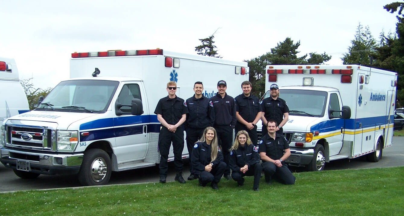 Submitted photo
Staff with Olympic Ambulance pose with Ambulances being donated to communities in Latin American and Caribbean countries.