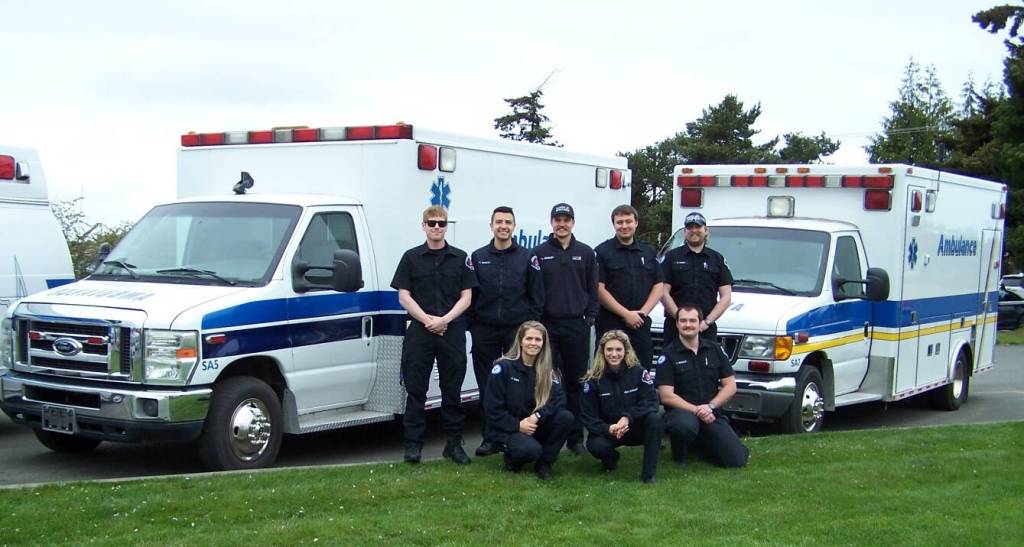 Submitted photo
Staff with Olympic Ambulance pose with Ambulances being donated to communities in Latin American and Caribbean countries.