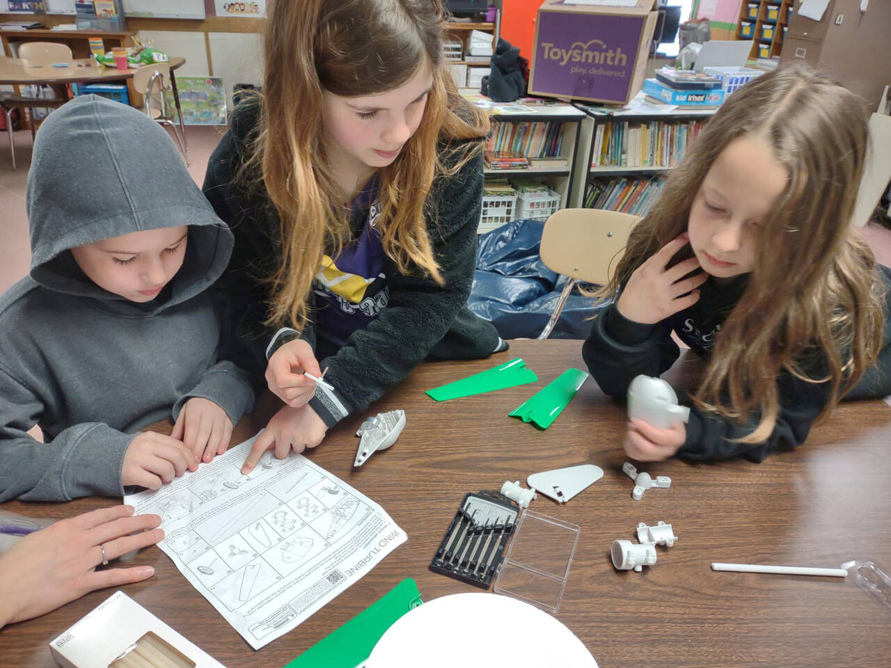 Submitted photo
Students at Helen Haller Elementary School  from left, Tyler Speed, Selene Dorkin and Ellie Roedell  build wind turbines in a lesson about wind power and layers of soil.