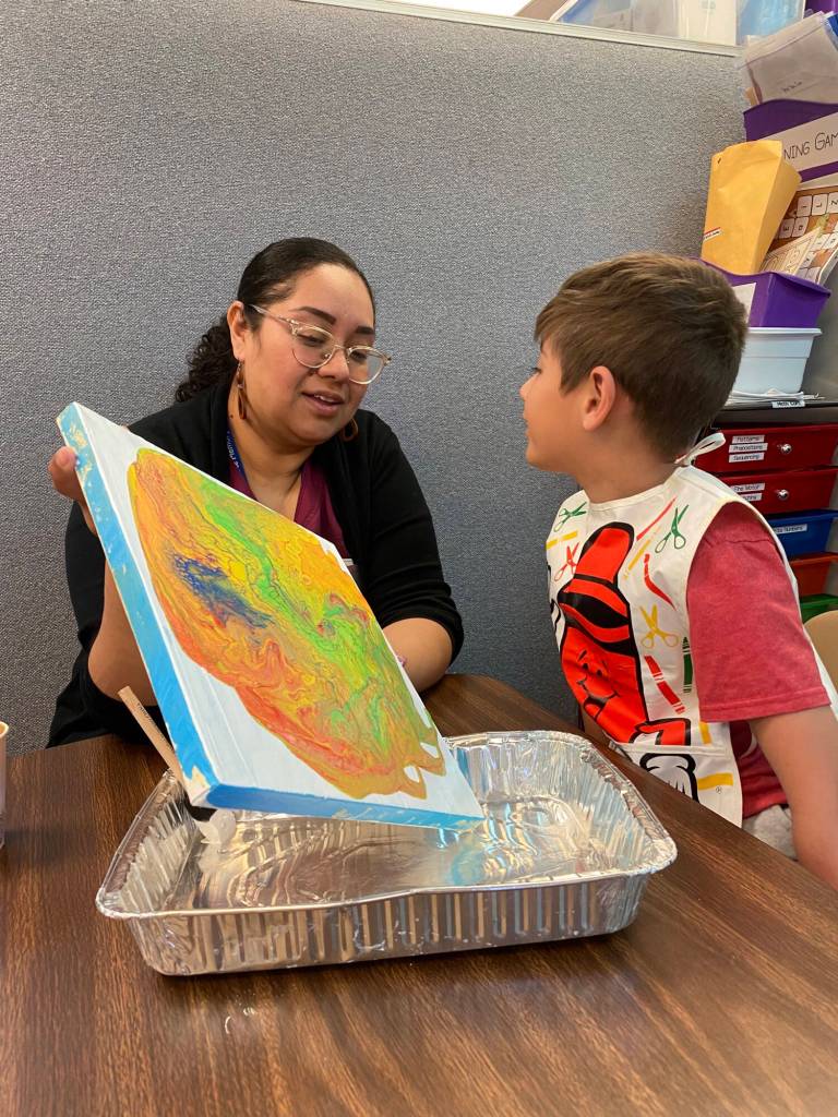 Submitted photo
Helen Haller Elementary student Liam Johnson paints with his mom during a recent project at Helen Haller Elementary School.