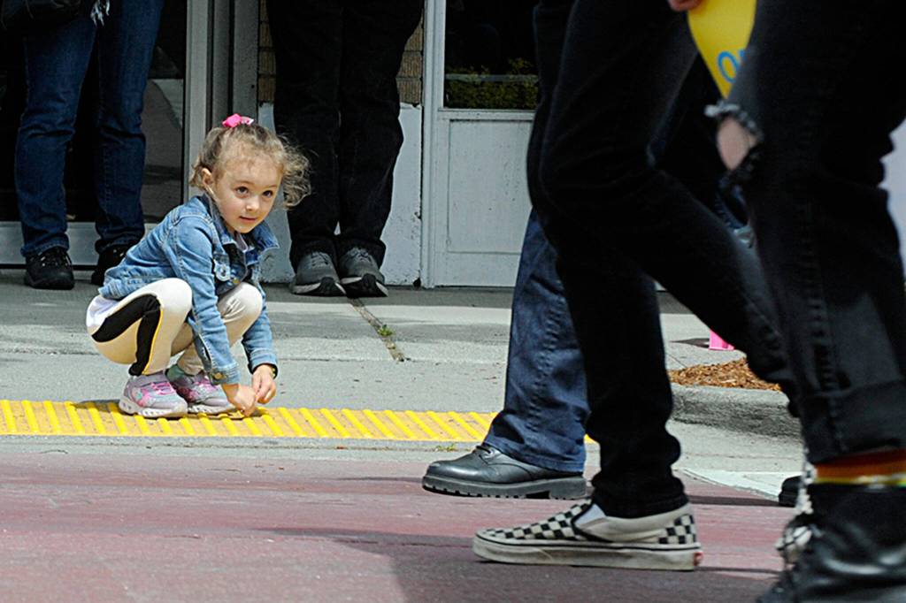Sequim Gazette photo by Matthew Nash
Lilee Perez, 5, grabs candy as the Sequim FFA walks by in the Sequim Irrigation Festival Grand Parade. Lilees grandma said they came to watch her older brother in the band.