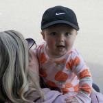 Sequim Gazette photo by Matthew Nash/ Seven-month-old Elena Hueter enjoys her first Grand Parade from the shade with mom Ali.
