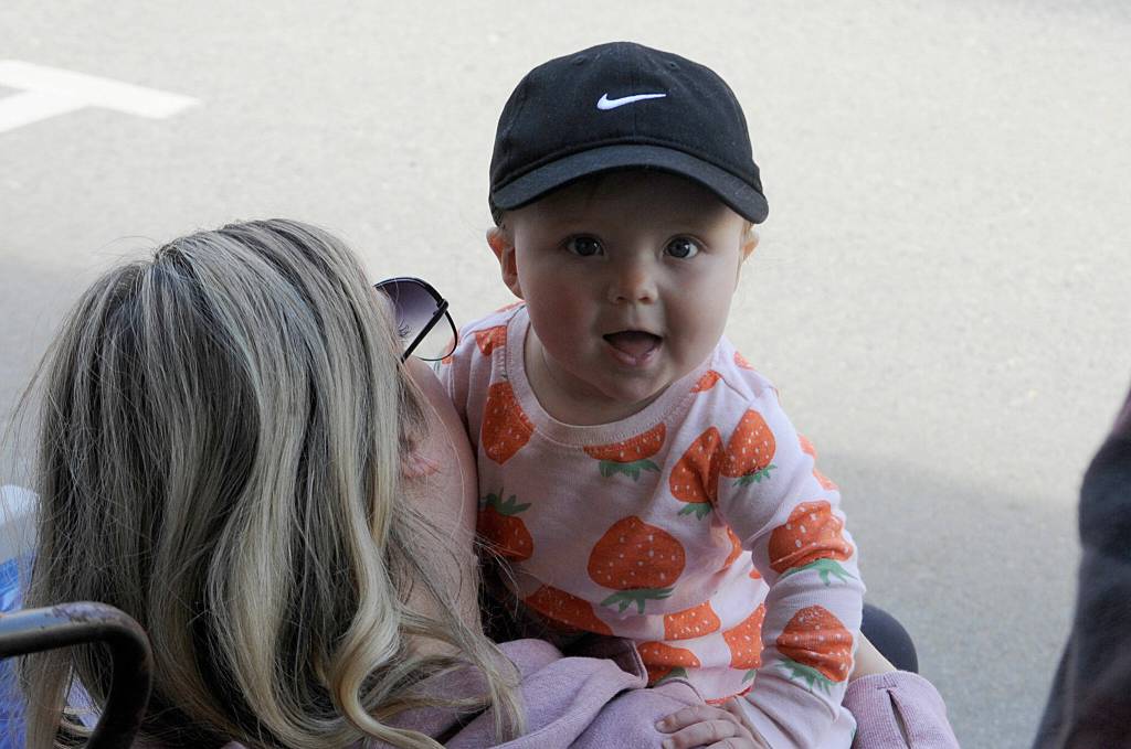 Sequim Gazette photo by Matthew Nash/ Seven-month-old Elena Hueter enjoys her first Grand Parade from the shade with mom Ali.