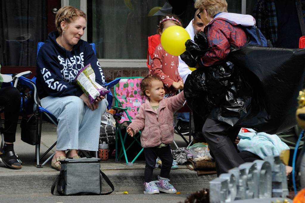 Sequim Gazette photo by Matthew Nash/ Nineteen-month-old Ember Meier receives a balloon on Saturday during the Grand Parade.