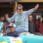 Michael Dashiell/Sequim Gazette
Jean Wyatt, the 2022 Sequim-Dungeness Valley Chamber of Commerces Citizen of the Year, waves to the crowd at Saturdays Grand Parade, hitching a ride with Paul McHugh.