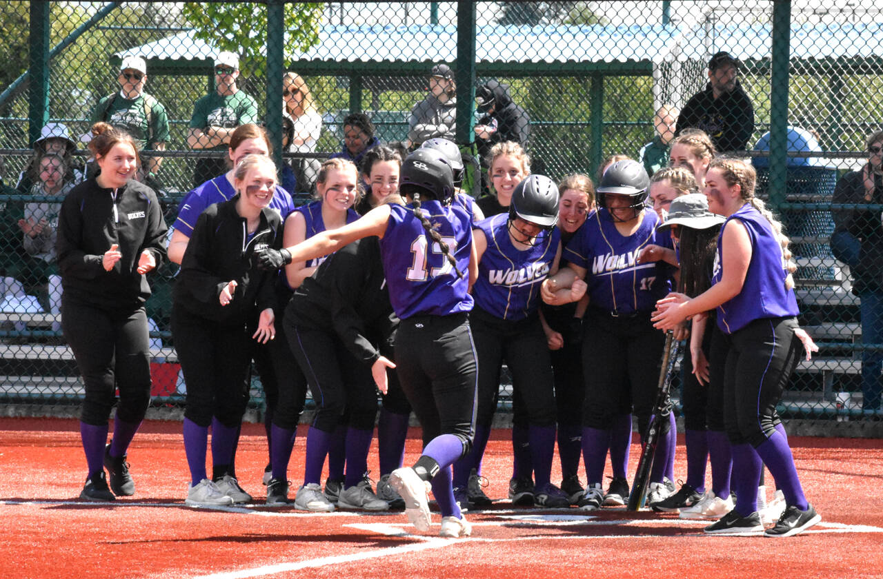 Photo by Kevin Hanson/Enumclaw Courier-Herald 
Sequim teammates celebrate Taylee Romes home run over the left field fence in the Wolves 21-1 rout of Sammamish on May 20, a win that secured Sequim a berth in the state 2A tournament.