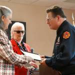 Sequim Gazette photoS by Michael Dashiell
Judy Tordini, left, and Melody Anderson of the Michael Trebert Chapter of the Daughters of the American Revolution present Blaine Zechenelly with the groups Distinguished Citizen of the Year Award at a recognition luncheon on May 10 at The Cedars at Dungeness. Zechenelly was honored for his work organizing first responder and Community Emergency Response Team (CERT) efforts in 2021. He wants us to make sure we can handle everything, Anderson said.