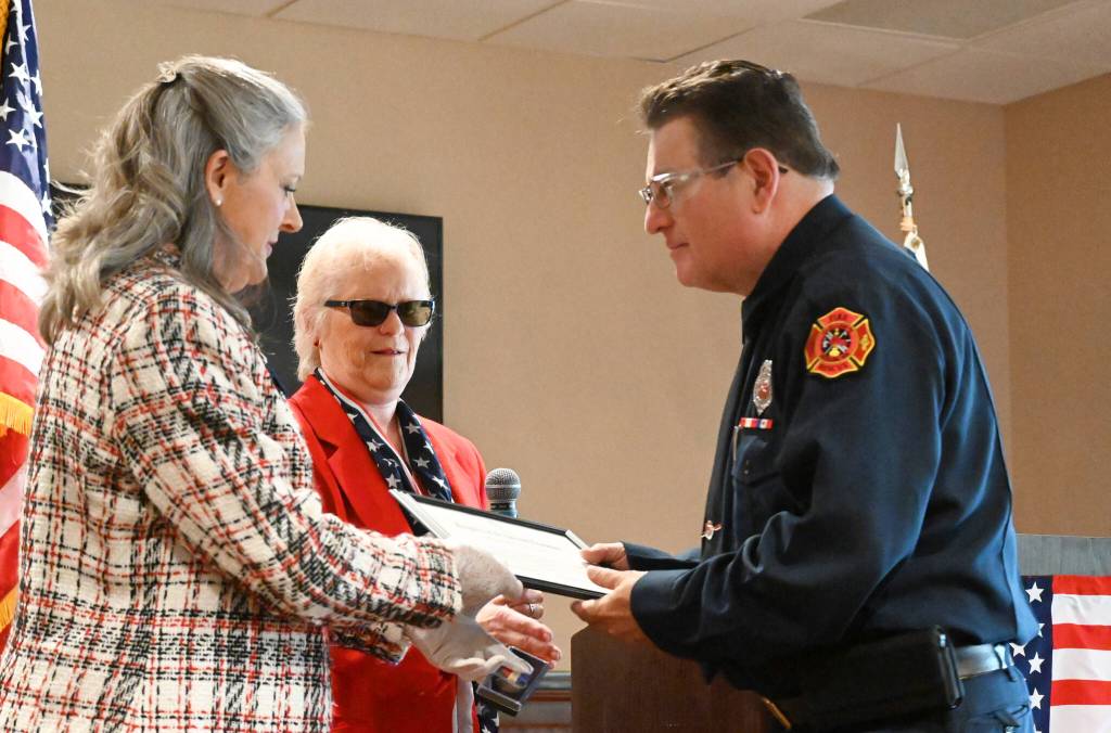 Sequim Gazette photoS by Michael Dashiell
Judy Tordini, left, and Melody Anderson of the Michael Trebert Chapter of the Daughters of the American Revolution present Blaine Zechenelly with the groups Distinguished Citizen of the Year Award at a recognition luncheon on May 10 at The Cedars at Dungeness. Zechenelly was honored for his work organizing first responder and Community Emergency Response Team (CERT) efforts in 2021. He wants us to make sure we can handle everything, Anderson said.