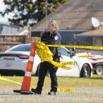 A Port Angeles police officer cordons off an empty lot at West Washington Street and Third Avenue Thursday morning as law enforcement officials investigate an incident in the area. Sequim Gazette photo by Michael Dashiell