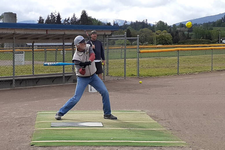 Sequim Grey Wolves Joel Hecht (batting) and David Unruh get some practice in at the Carrie Blake Community Park softball fields recently. The Grey Wolves have opened registration for the 2022 season. Photo by Annette Hanson