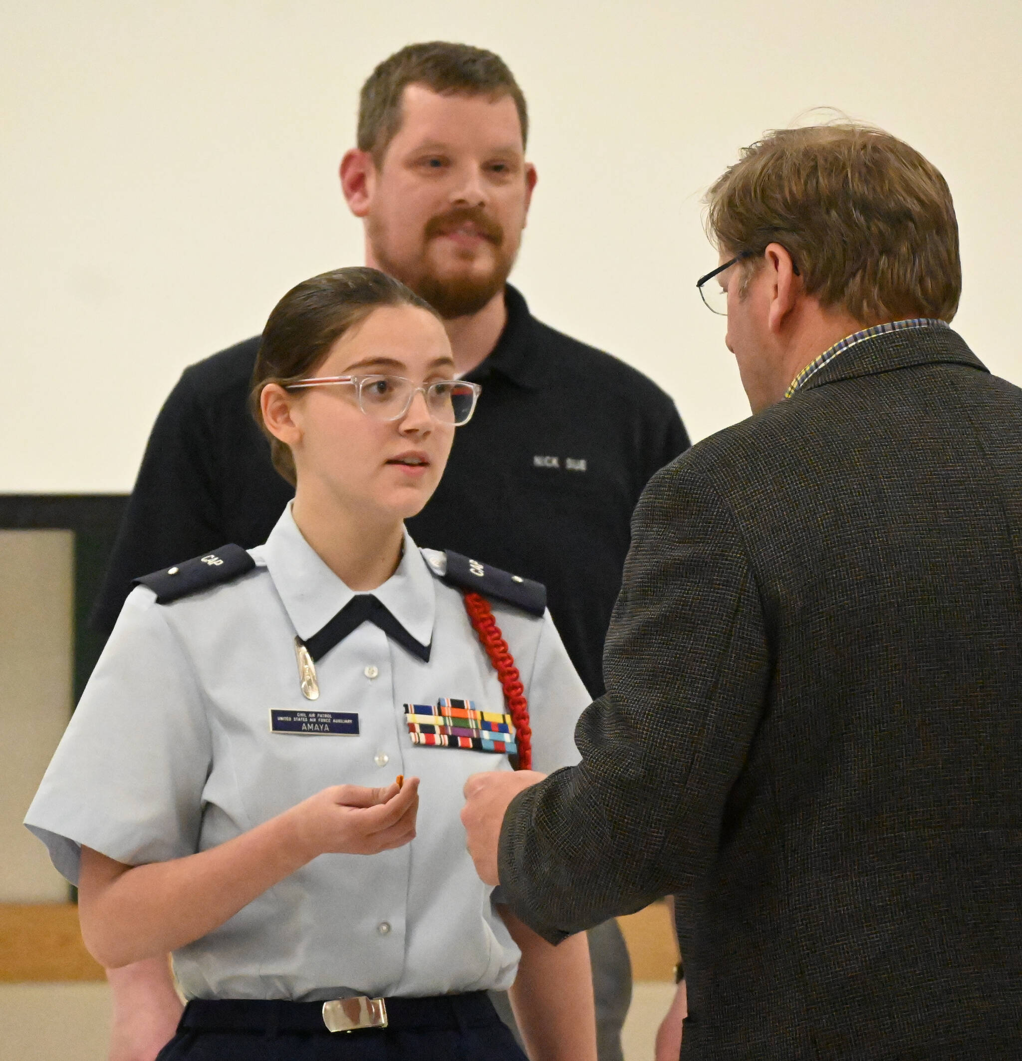 With Deputy Commander of Cadets Capt. Nick Sue looking on, Faith Amaya of Sequim is congratulated by State Rep. Mike Chapman, right, for Amayas promotion to Cadet Second Lieutenant on May 17. Sequim Gazette photo by Michael Dashiell